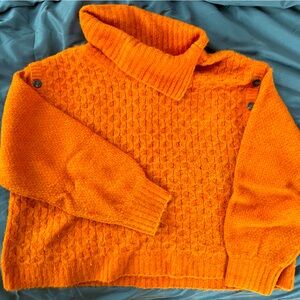 Bright orange wool sweater with fun accent buttons on shoulders.